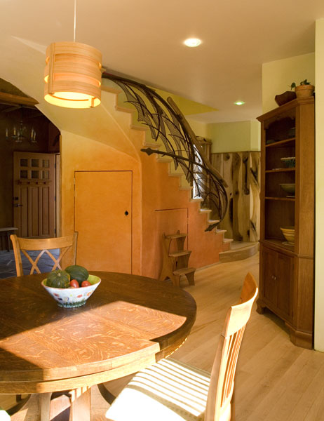 Kitchen as the heart of the home - views towards the main entrance and recycled steel staircase.
