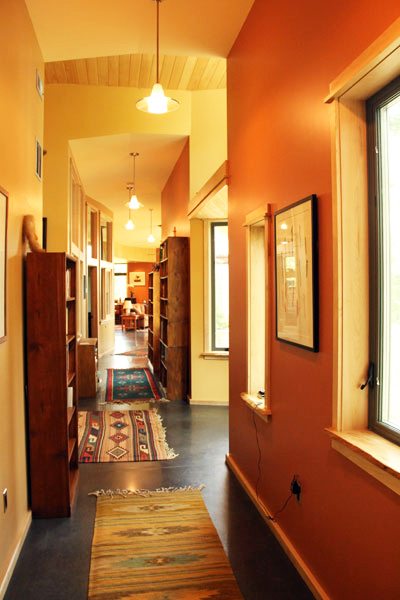 Long hallway with plenty of natural light opens up to all rooms in the house.