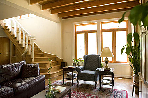 Living room with lots of natural light and wood beams.