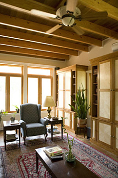 Large living room windows and repurposed wood cabinetry.