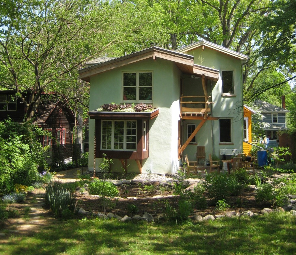Contact Us - Beth & Bill's Straw bale addition with green roof and sleeping porch looks out into the regenerative landscaped garden.