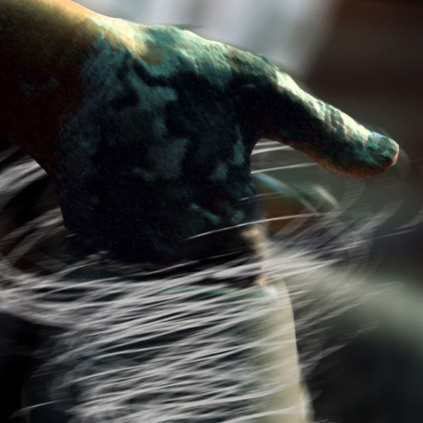 Image of hand with ceramic wheel.