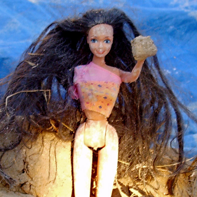 Barbie doll in mud